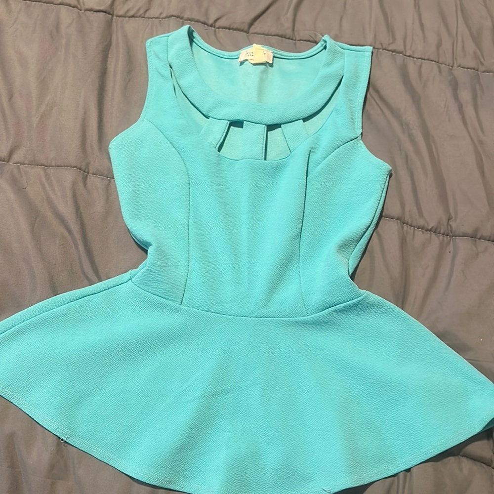 Light blue peplum shirt, has a cutout top. Size small